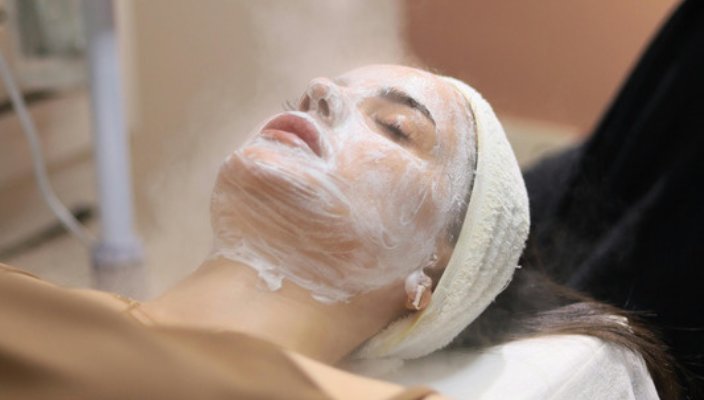 Guest relaxing with a creamy facial mask applied